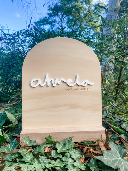Business signage - wooden layered arch